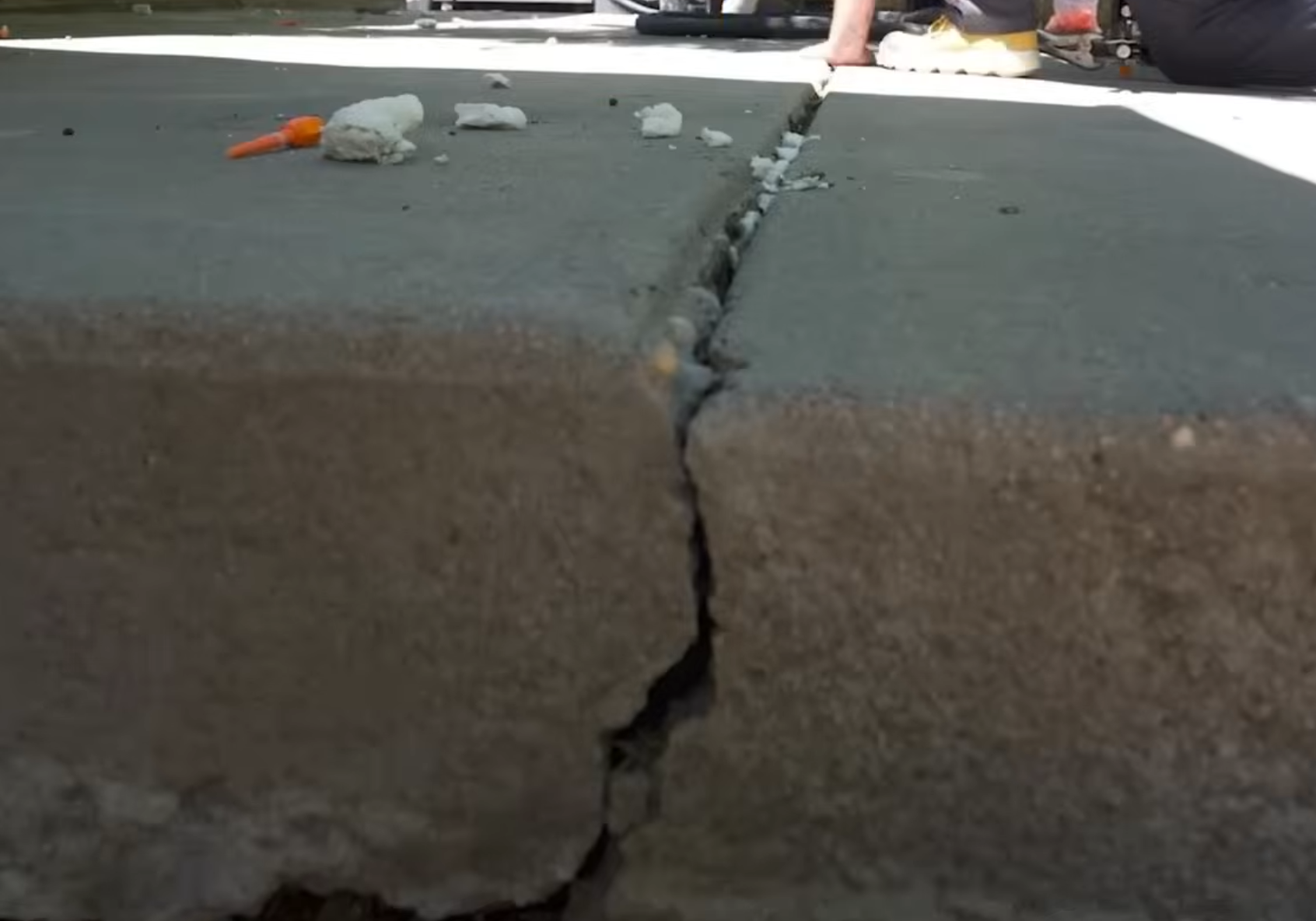 Before concrete leveling - sunken driveway panel