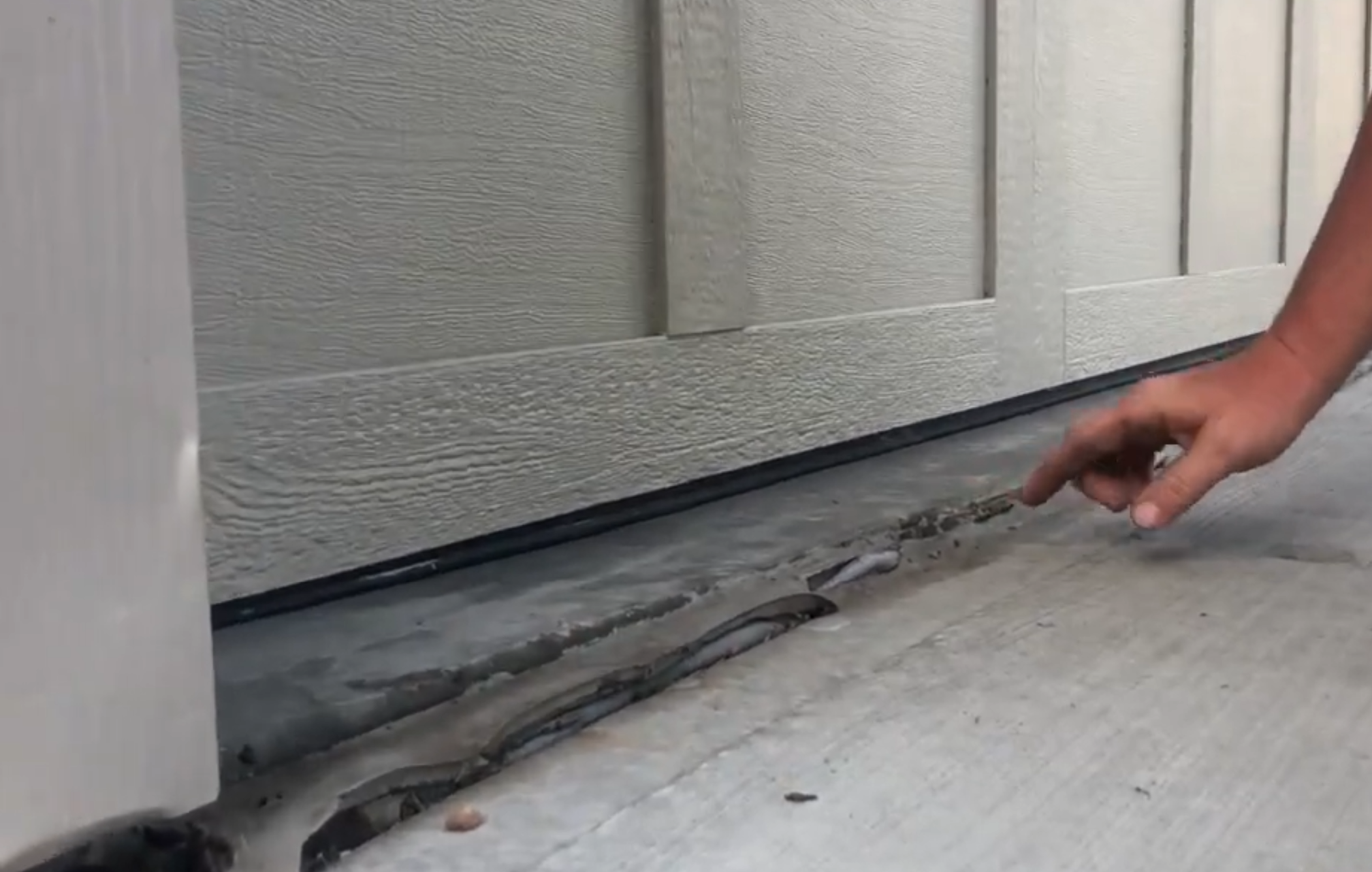 Sunken driveway before concrete leveling